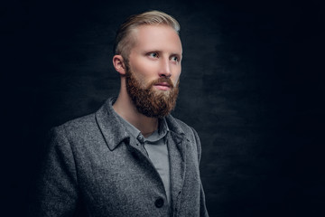 Bearded blond male dressed in elegant, classic jacket.