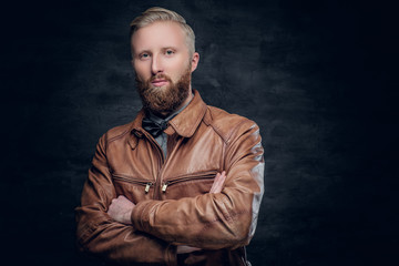 Bearded male dressed in a brown leather jacket.