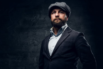 A man in woolen jacket and tweed cap.