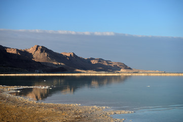 Fototapeta na wymiar Dead Sea and the coast, lit by the sun in the evening 