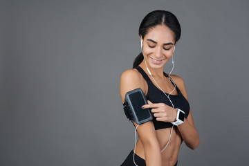 Charming sporty girl choosing necessary song