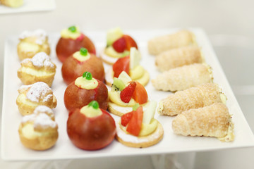 Tasty bakery with berries and fruits served on white plate