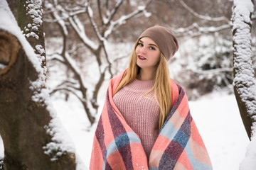 Young happy teenage girl enjoy snow in winter city park outdoor