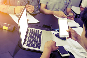 Business meeting time. Photo young account managers crew working with new startup project. Notebook on wood table. Idea presentation, analyze plans. Wide,film effect