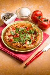 pizza with fresh tomatoes mozzarella arugula and capers