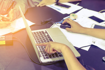 Business meeting time. Photo young account managers crew working with new startup project. Notebook on wood table. Idea presentation, analyze plans. Wide,film effect