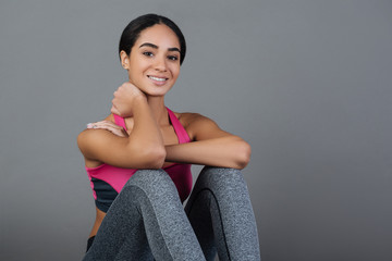 Obraz premium Relaxed smiling female sitting after training