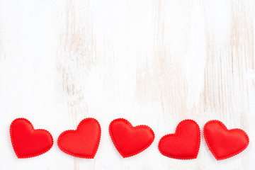 vintage white wooden background with red hearts