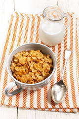 cornflakes in a grey mug on kitchen towel