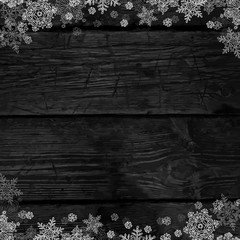 Wooden black christmas background with snowflakes. Frozen orname