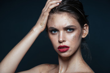 Beauty portrait of attrative young woman with sparkling fashion makeup