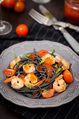 Black spaghetti with shrimps and red caviar