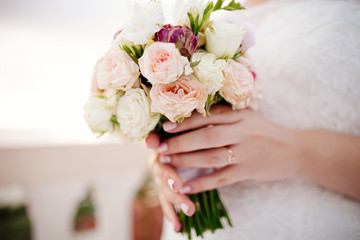 newlyweds holding wedding bouquet