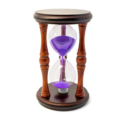 Brown hourglass with violet sand isolated on white backghound