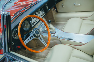 Detail of interior red sports car steering wheel speedometer
