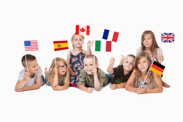 poland group holding flags of different countries. German flag, flag england, spain flag, flag of america, flag of russia, france flag, flag canada 