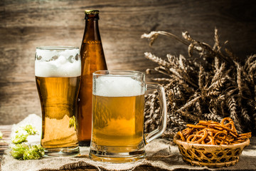 Mug, glasse, beer bottle with wheat spikelets, hops , pretzels