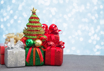Christmas gift box and decoration on light bokeh background
