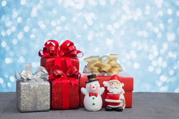 Christmas gift box and decoration on light bokeh background