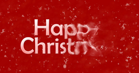 Happy Christmas text turns to dust from right on red background