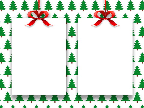 Two blank frames hanged by red Christmas ribbons against green trees pattern background