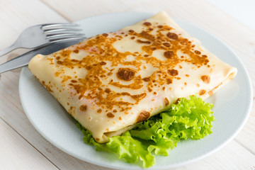 Russian delicious pancakes on a white plate
