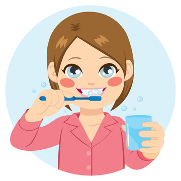 Cute little girl brushing teeth and holding glass of water