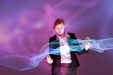 Composite image of redhead businesswoman using interactive desk