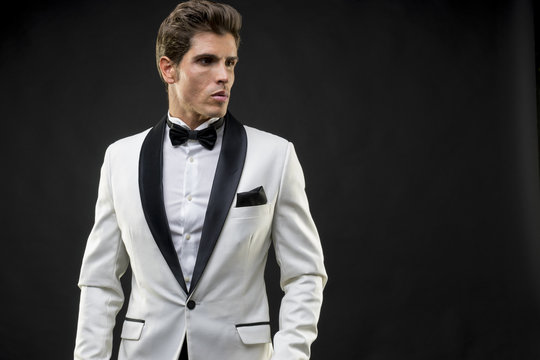 Luxury, Elegant Man In A White Suit Tuxedo With Bow Tie Around H