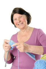 Portrait of laughing elderly woman with yarn and knitting needle