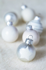 White Christmas balls on white pelt. Selective fosuc