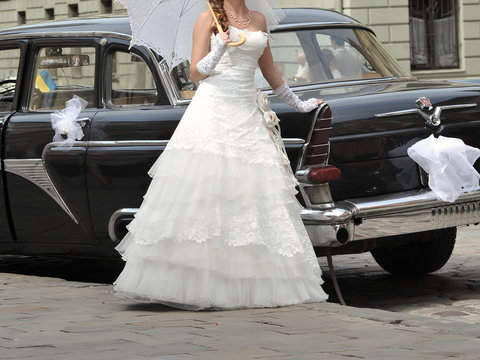 bride with groom near old car