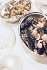 Dish with Clams and Sailors Mussels with a Glass of White Vine