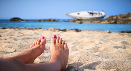 A girl sunbathes on a beach of Formentera in the Balearic Islands, Spain