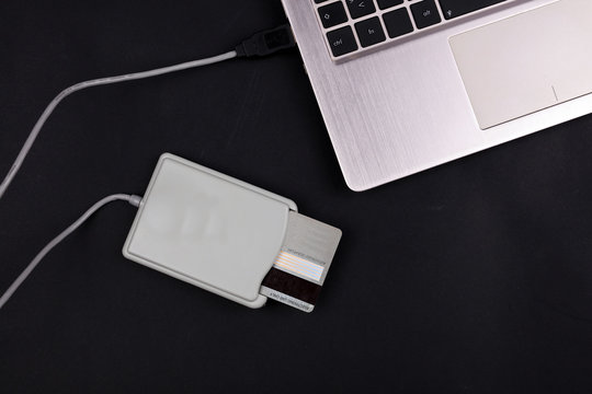 Online banking. Paying bills online with debit, credit card with laptop and card reader
