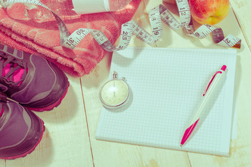 Shoes and sports equipment on wooden floor, top view