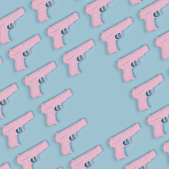 Colorful pastel pattern made of pink handguns with copy space. M