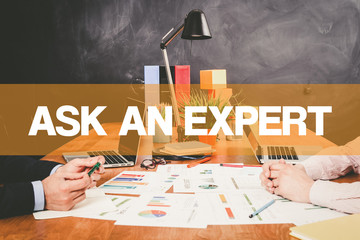 Two Businessman Ask An Expert working in an office