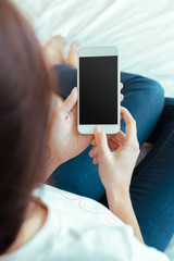 Woman with modern mobile phone in hands