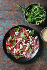 Beef carpaccio with arugula and sauce