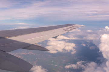 Fototapeta premium Blue sky and Clouds as seen through window of aircraft