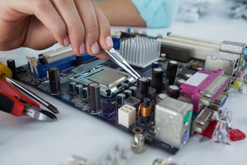 Fototapeta na wymiar Female computer engineer repairing computer motherboard