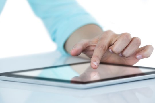 Hand using digital tablet against white background