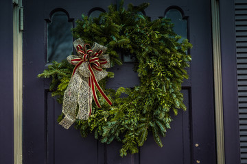 Evergreen Christmas wreath on purple door