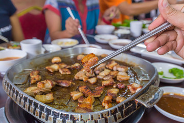 delicious grilled pork barbecue, meat are being cooked on stove