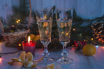 Christmas holidays with two glass of champagne and burning candle