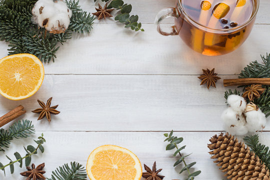 Christmas, New Year winter holiday white wooden background and frame with a cup of tea and oranges