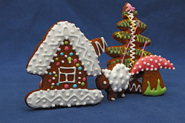 gingerbread cookies on blue background, house, tree, mushroom, s