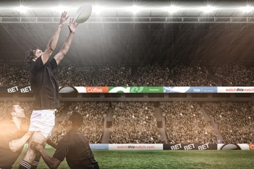 Composite image of rugby fans in arena