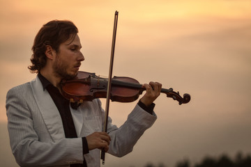 Professional violinist with the violin late evening silhouette